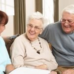 elderly couple sitting on couch going through an aged care assessment